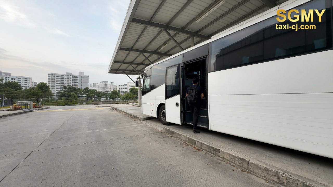 Dawn coach bay in Singapore, passengers from behind