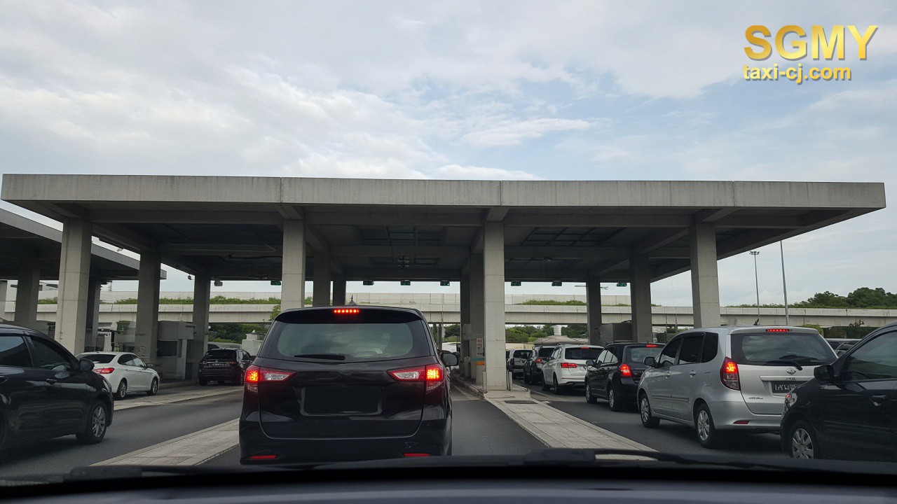 Car approaching a Woodlands Checkpoint inspection lane, seen from the windshield